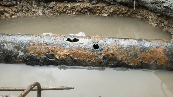 Corroded pipe leaking under a slab in a Raleigh-Durham home